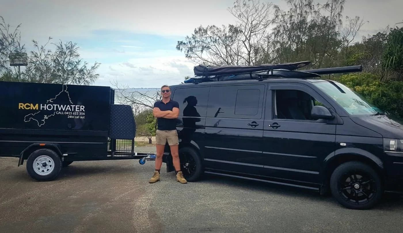 Richard from RCM Hot Water beside the branded work van on the Sunshine Coast