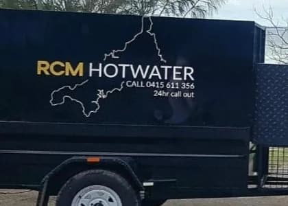 The RCM Hot Water trailer, lettered with the business name, phone number and 24 hour call out